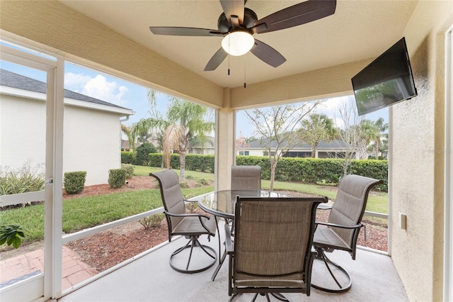 sunroom featuring a ceiling fan