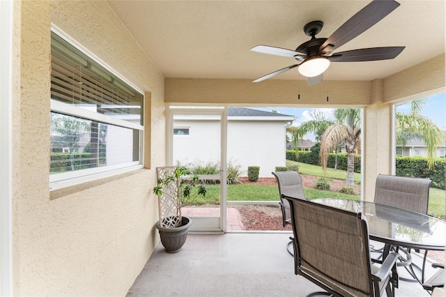 sunroom / solarium with a ceiling fan