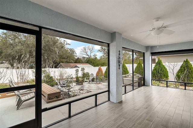 sunroom featuring ceiling fan