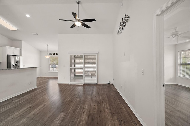 unfurnished living room featuring ceiling fan, dark hardwood / wood-style floors, and lofted ceiling