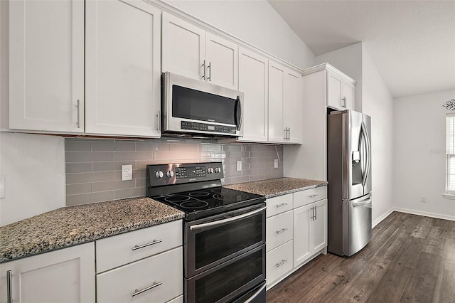 kitchen with backsplash, dark stone counters, stainless steel appliances, dark wood-type flooring, and white cabinets