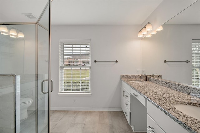 bathroom with vanity, an enclosed shower, and toilet