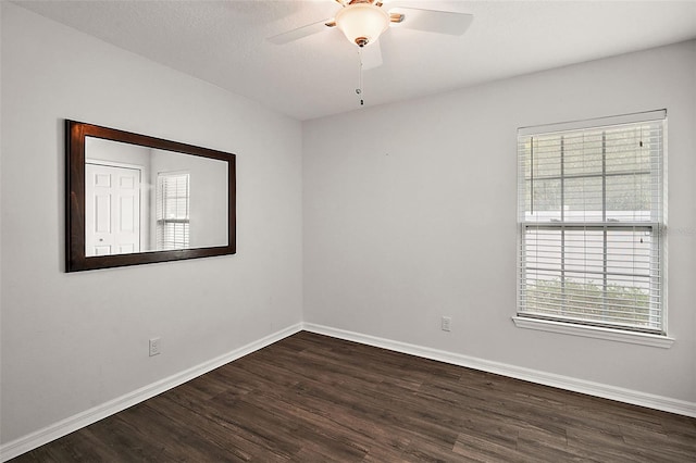 spare room with dark hardwood / wood-style flooring, ceiling fan, and a textured ceiling