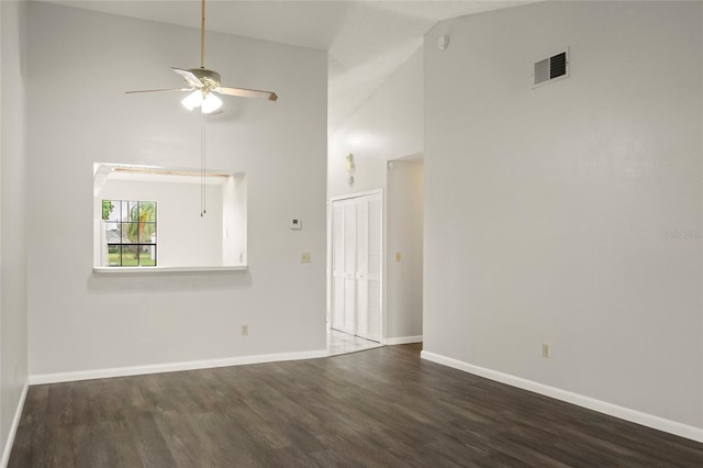 unfurnished room featuring baseboards, visible vents, a ceiling fan, dark wood-style flooring, and high vaulted ceiling