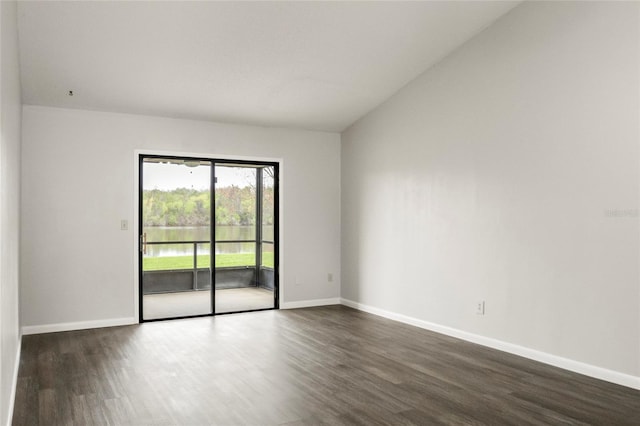 unfurnished room with dark wood-style flooring and baseboards