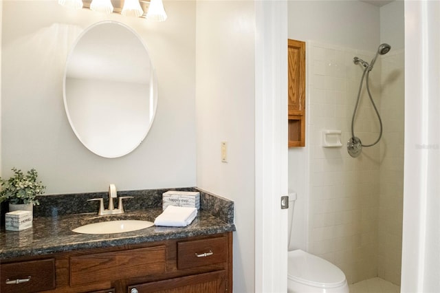 bathroom with vanity, a shower stall, and toilet