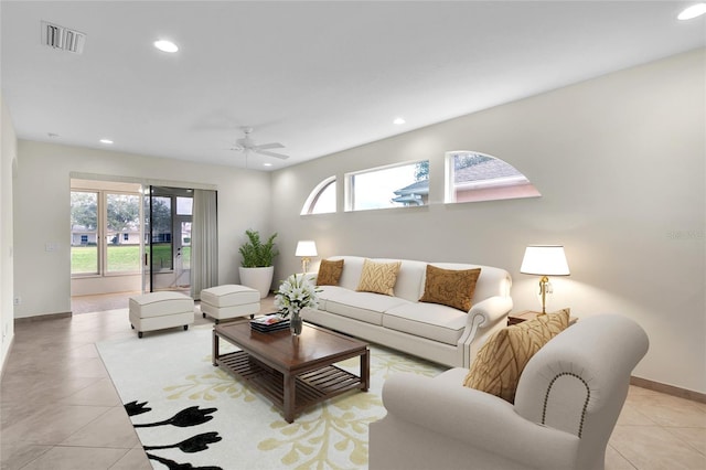 living room featuring light tile patterned flooring, baseboards, visible vents, and recessed lighting