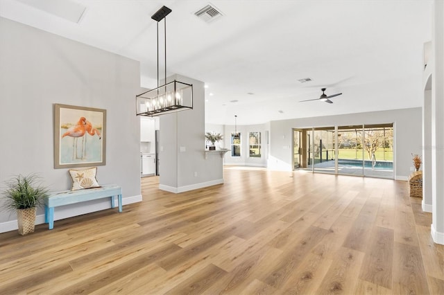 unfurnished living room with ceiling fan, a healthy amount of sunlight, and light hardwood / wood-style flooring