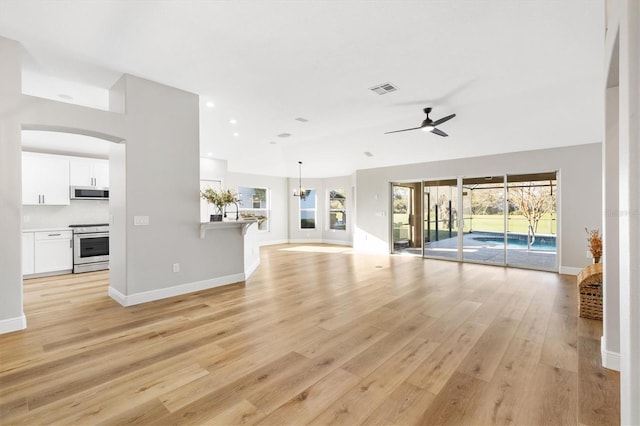 unfurnished living room featuring ceiling fan and light wood-type flooring