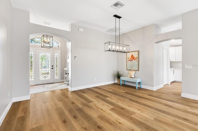 entryway featuring a notable chandelier and light hardwood / wood-style flooring