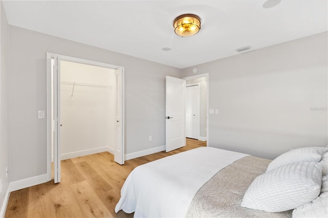 bedroom featuring light hardwood / wood-style flooring and a closet