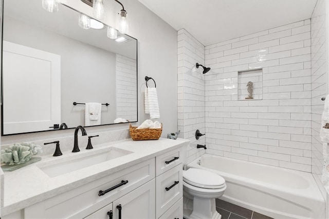 full bathroom featuring tile patterned flooring, toilet, vanity, and tiled shower / bath