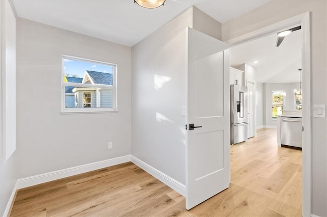 corridor with light hardwood / wood-style flooring