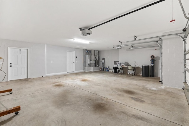 garage with water heater and a garage door opener