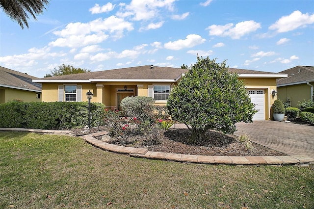 ranch-style house featuring a garage, a front lawn, decorative driveway, and stucco siding