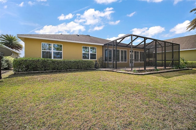 back of house with a lanai, a yard, and stucco siding