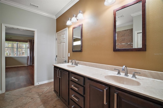 full bathroom with double vanity, crown molding, a sink, and tile patterned floors