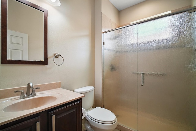 full bathroom with a shower stall, vanity, and toilet