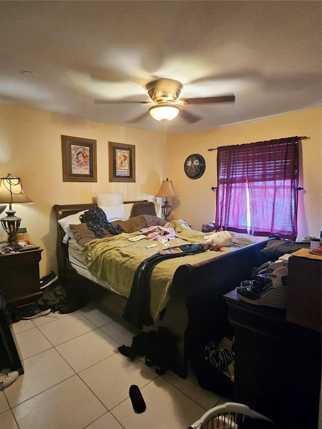 bedroom with ceiling fan and light tile patterned floors