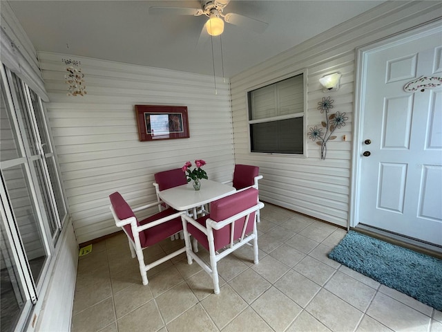 sunroom featuring ceiling fan