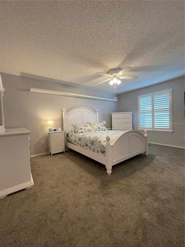 unfurnished bedroom with ceiling fan, dark colored carpet, and a textured ceiling