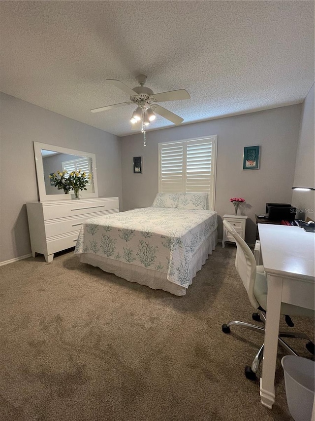 carpeted bedroom featuring ceiling fan and a textured ceiling