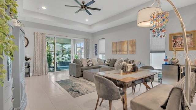 living room featuring recessed lighting, ceiling fan, a raised ceiling, and tile patterned floors