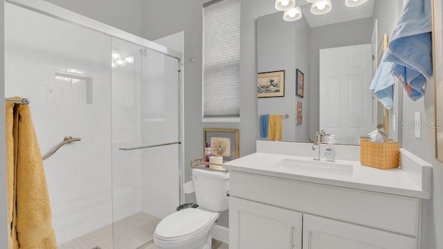 full bathroom with vanity, a shower stall, and toilet