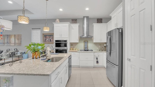 kitchen featuring white cabinets, wall chimney exhaust hood, stainless steel appliances, a sink, and light tile patterned flooring