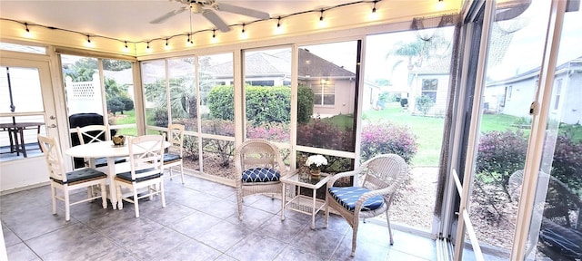 sunroom featuring a ceiling fan