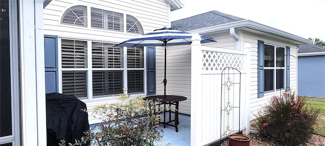 exterior space with roof with shingles