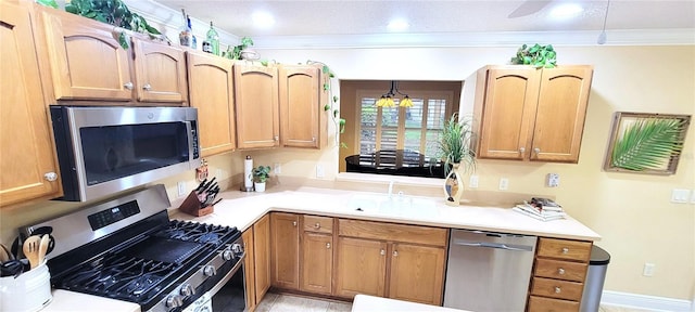 kitchen with recessed lighting, a sink, light countertops, appliances with stainless steel finishes, and crown molding