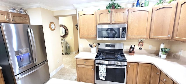 kitchen with stainless steel appliances, light countertops, ornamental molding, and light tile patterned floors