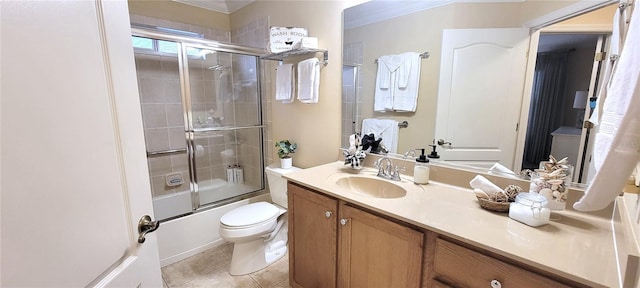 bathroom featuring toilet, ornamental molding, enclosed tub / shower combo, vanity, and tile patterned floors