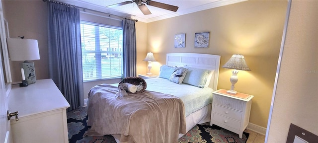 bedroom featuring ornamental molding, a ceiling fan, and baseboards