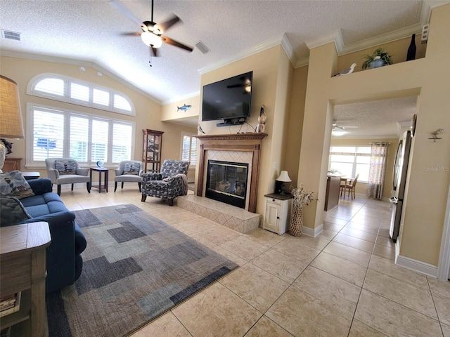 living area featuring plenty of natural light, light tile patterned floors, visible vents, and ornamental molding