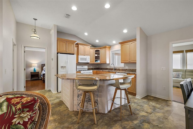 kitchen featuring white appliances, visible vents, a kitchen island, glass insert cabinets, and a breakfast bar area