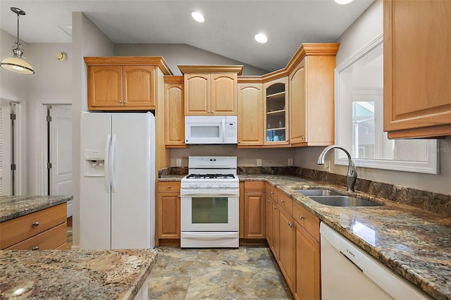 kitchen featuring white appliances, a sink, hanging light fixtures, dark stone counters, and glass insert cabinets