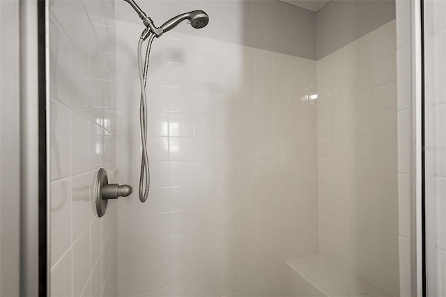 interior details with a tile shower