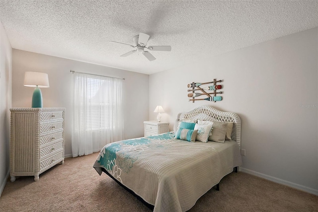 carpeted bedroom featuring ceiling fan, a textured ceiling, and baseboards