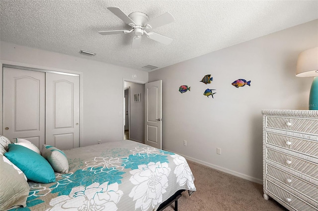 carpeted bedroom featuring a closet, visible vents, ceiling fan, a textured ceiling, and baseboards