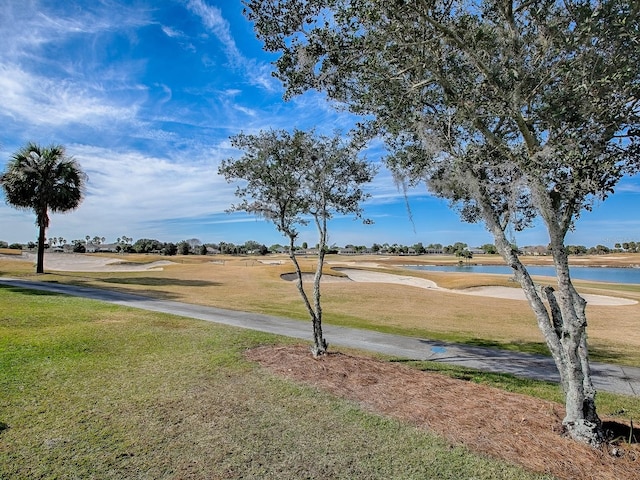 view of community with a yard and a water view