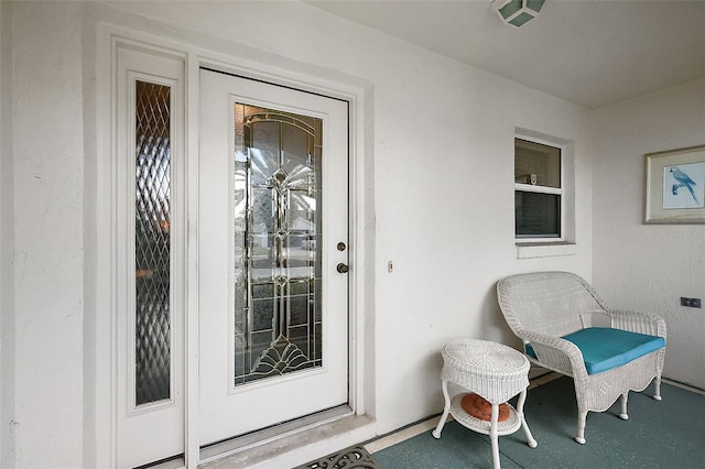 view of exterior entry with stucco siding