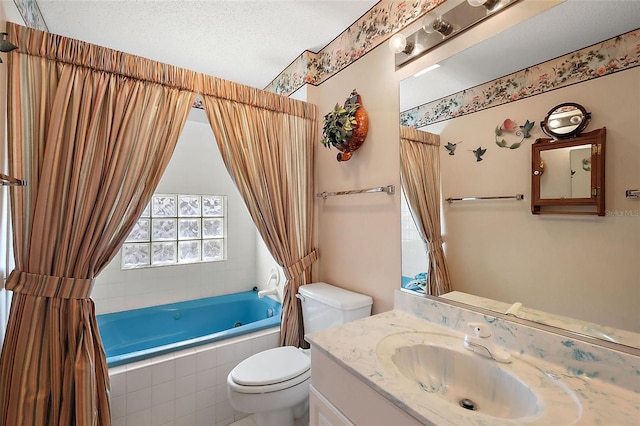 bathroom featuring a textured ceiling, vanity, and toilet