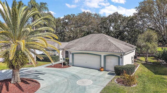 view of front of home with an attached garage, a shingled roof, concrete driveway, stucco siding, and a front lawn