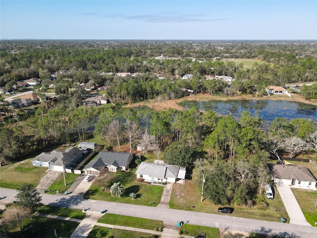 drone / aerial view featuring a residential view and a view of trees