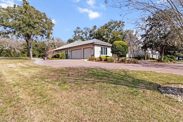 view of property exterior with a garage and a yard