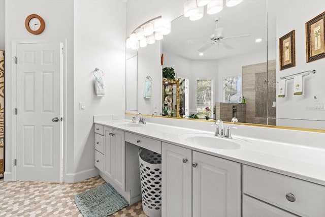 bathroom with ceiling fan, vanity, and walk in shower