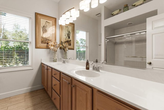 bathroom featuring wood-type flooring, vanity, and a shower with door