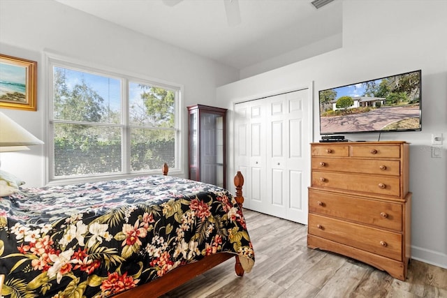 bedroom featuring light wood-type flooring, a closet, and ceiling fan